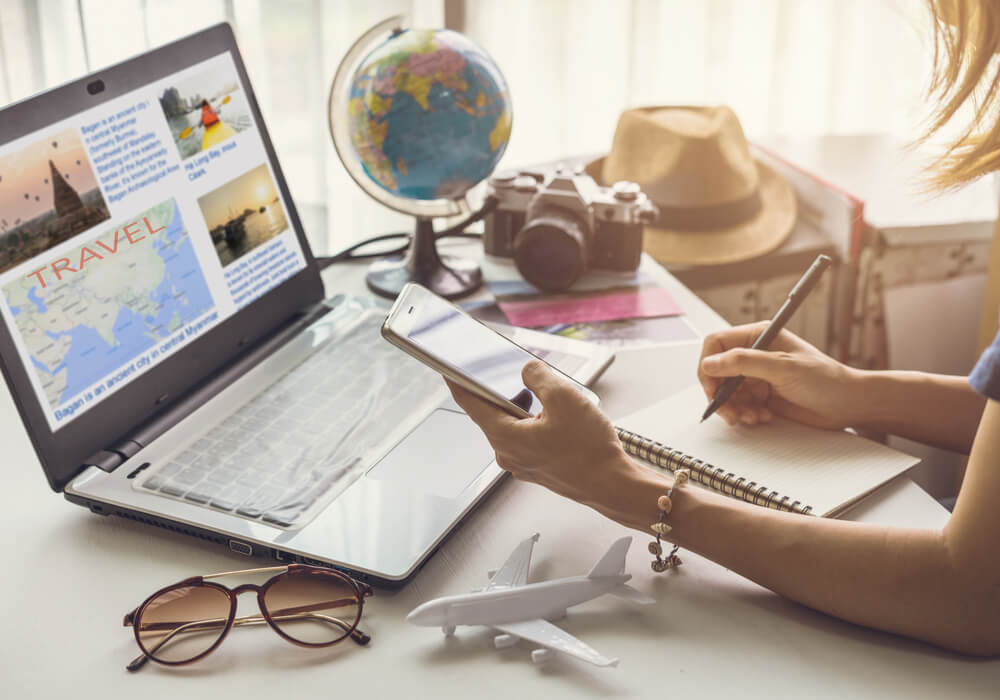 young woman planning a trip and making a list